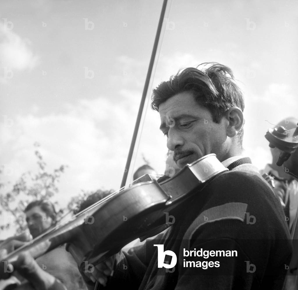 Violonist during Christening of Evangelist Gypsies, Arminvillier, France, May 30, 1957 (b/w photo)