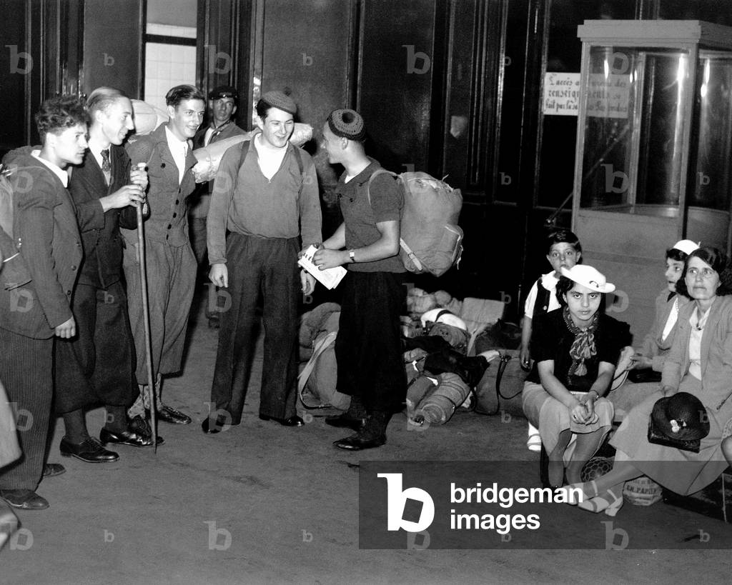 Departure For Holidays in Mountain (Young People With Rucksacks, Stick For Walking) in A Station in Paris, 1938 (b/w photo)