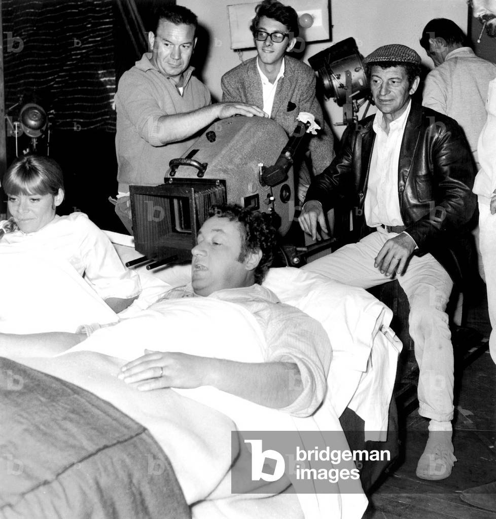 Director Yves Robert and Stepson and Actor Xavier Gelin (The Son of Danieledelorme and Daniel Gelin) With Cast Francoise Brion and Philippe Noiret (In Bed) on Set of Film Very Happy Alexander August 19, 1967 (b/w photo)