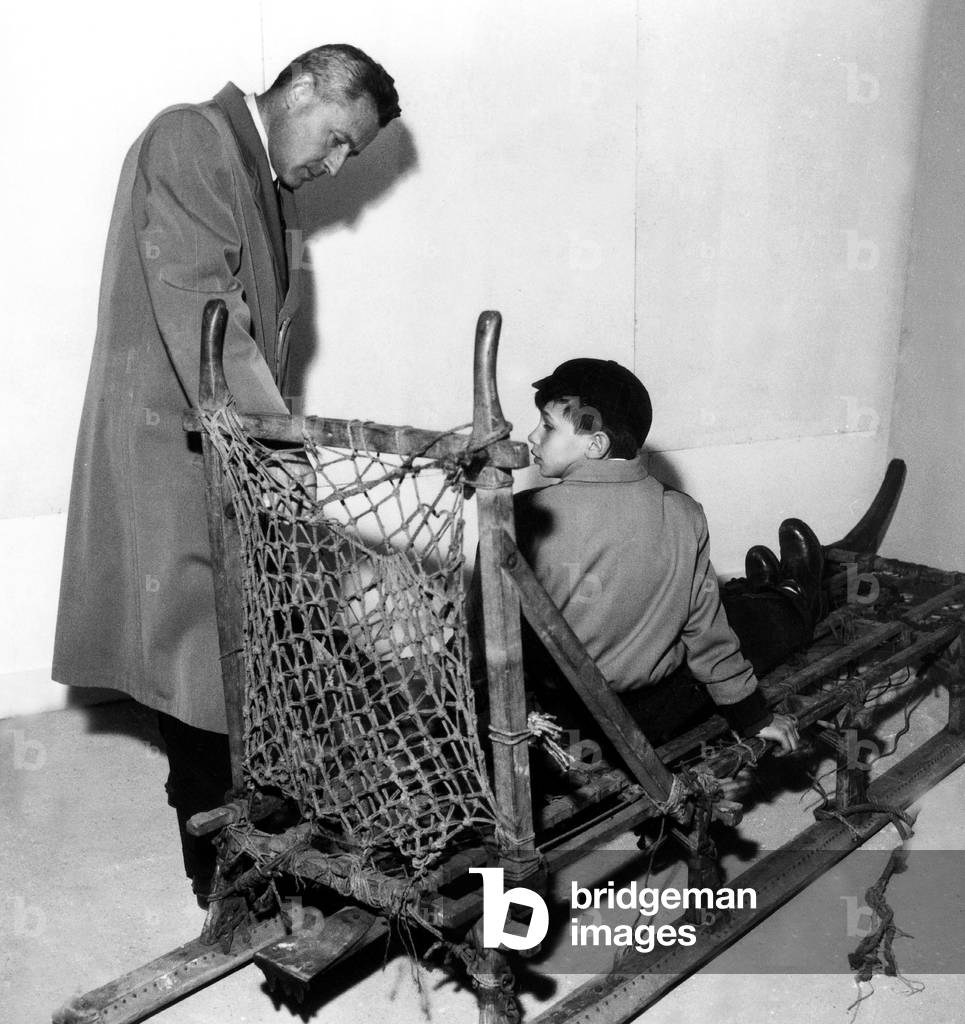 French Explorer Paul-Emile Victor and the Sleigh He Used in his Explorations here at Exhibition About Greenland in Paris April 8, 1953 (b/w photo)