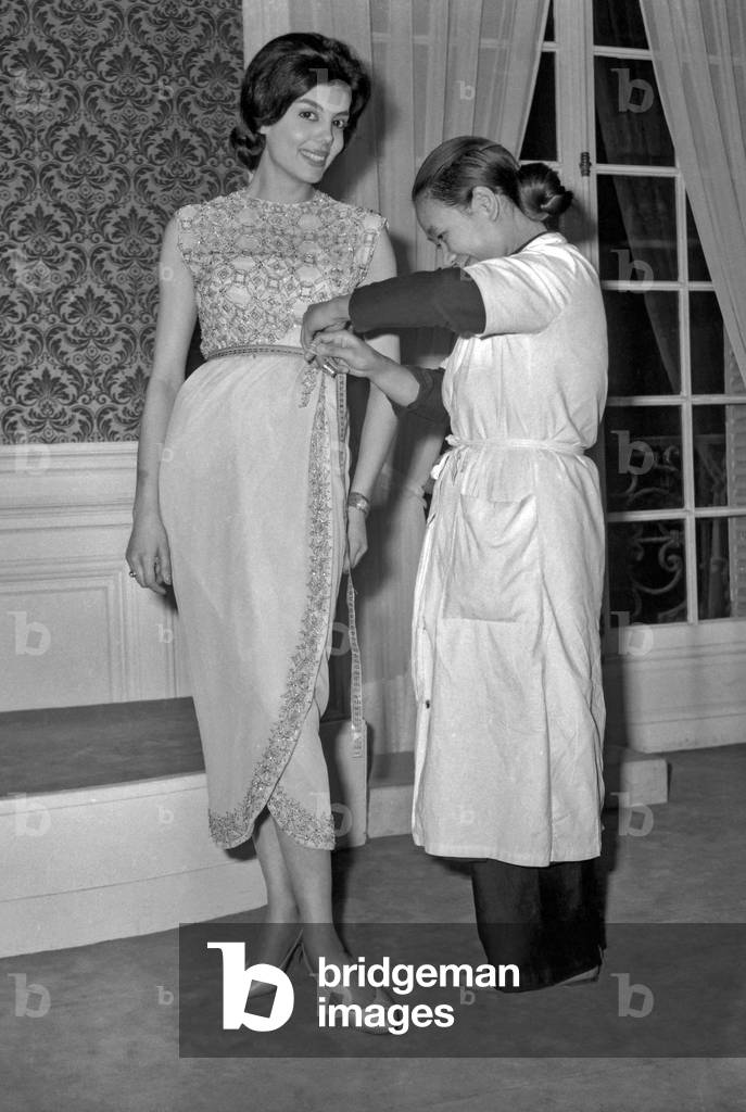 Norma Gladys Cappagli, Miss World, trying on a dress by Maggy Rouff, Paris, November 18, 1960 (b/w photo)