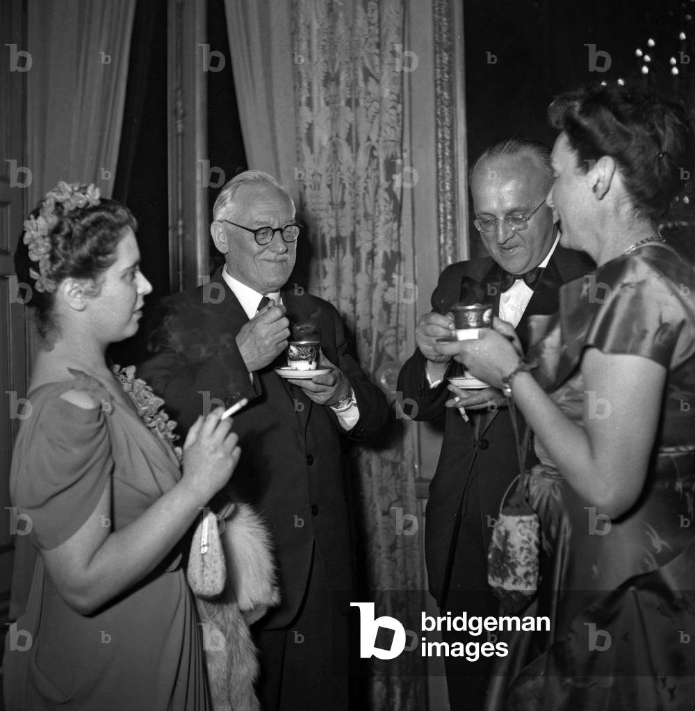 Conference of 4 ministers of Foreign affairs (USA, France, USSR, UK about Germany), diner at the Elysee, Paris, May 25, 1949 : Mrs Bogomolov, Andrei Vichynski and Alexandre Bogomolov (b/w photo)