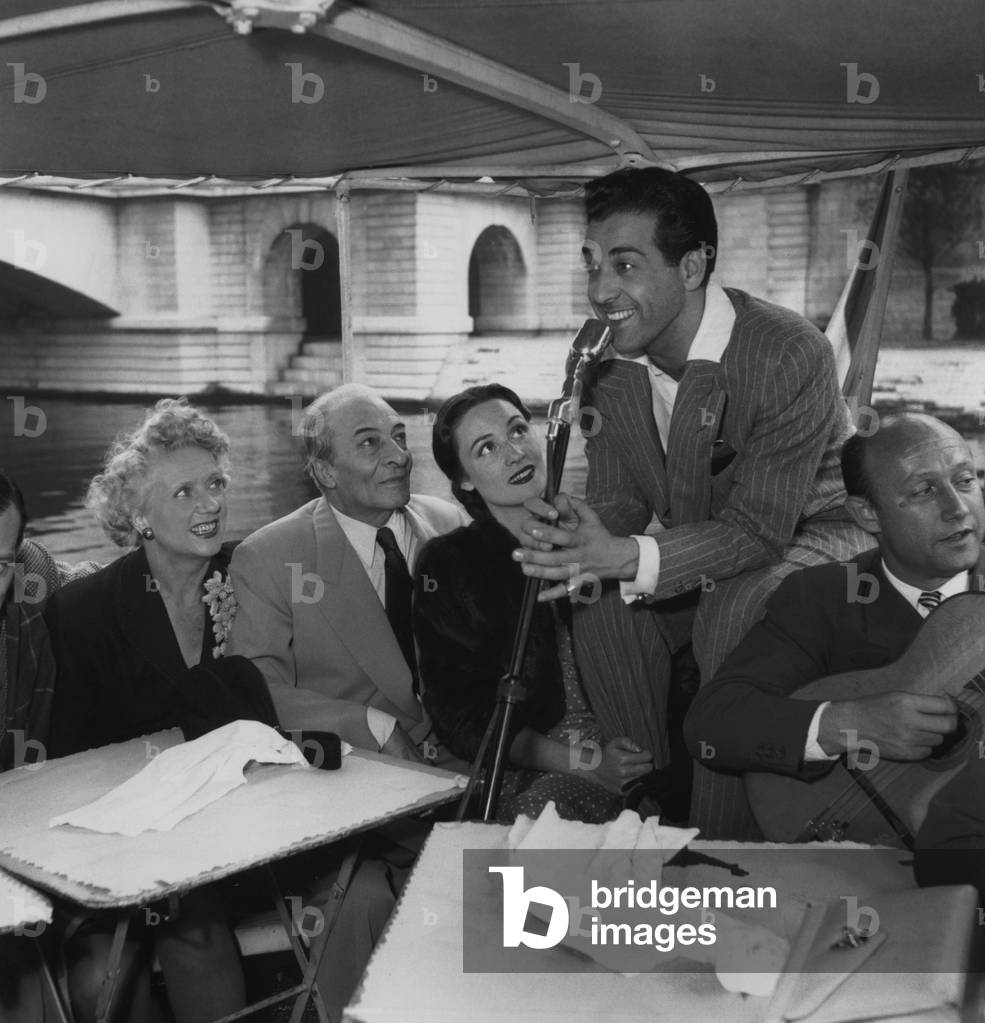Denise Grey, Jules Benrry, Maria Mariban Listening To Luis Mariano Singing and Roger Lucchesi Playing The Guitar August 29, 1949 during Diner Large River Boat Over The Seine River in Paris during-Filming of 