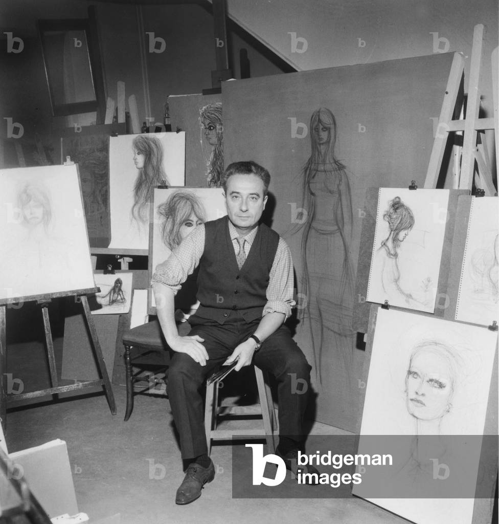Jean Carzou in his Workshop With Portraits of Brigitte Bardot, 1965 (b/w photo)