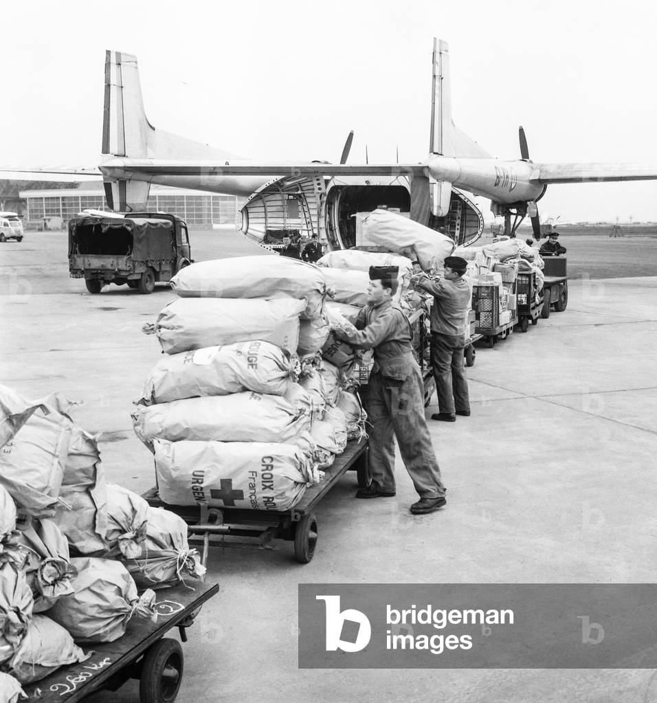 Clothes, shoes and foodd are sent by military planes to Madagascar after the cyclones, April 2, 1959 (b/w photo)