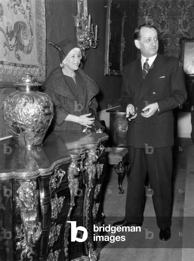 Andre Malraux, French Minister of Culture, at Opening of Exhibition About A Century of Elegance in Presence of Lady Jebb Wife of English Ambassador in Paris here Looking at A 18Th Century Chest of Drawers and Vase, February 25, 1959 (b/w photo)