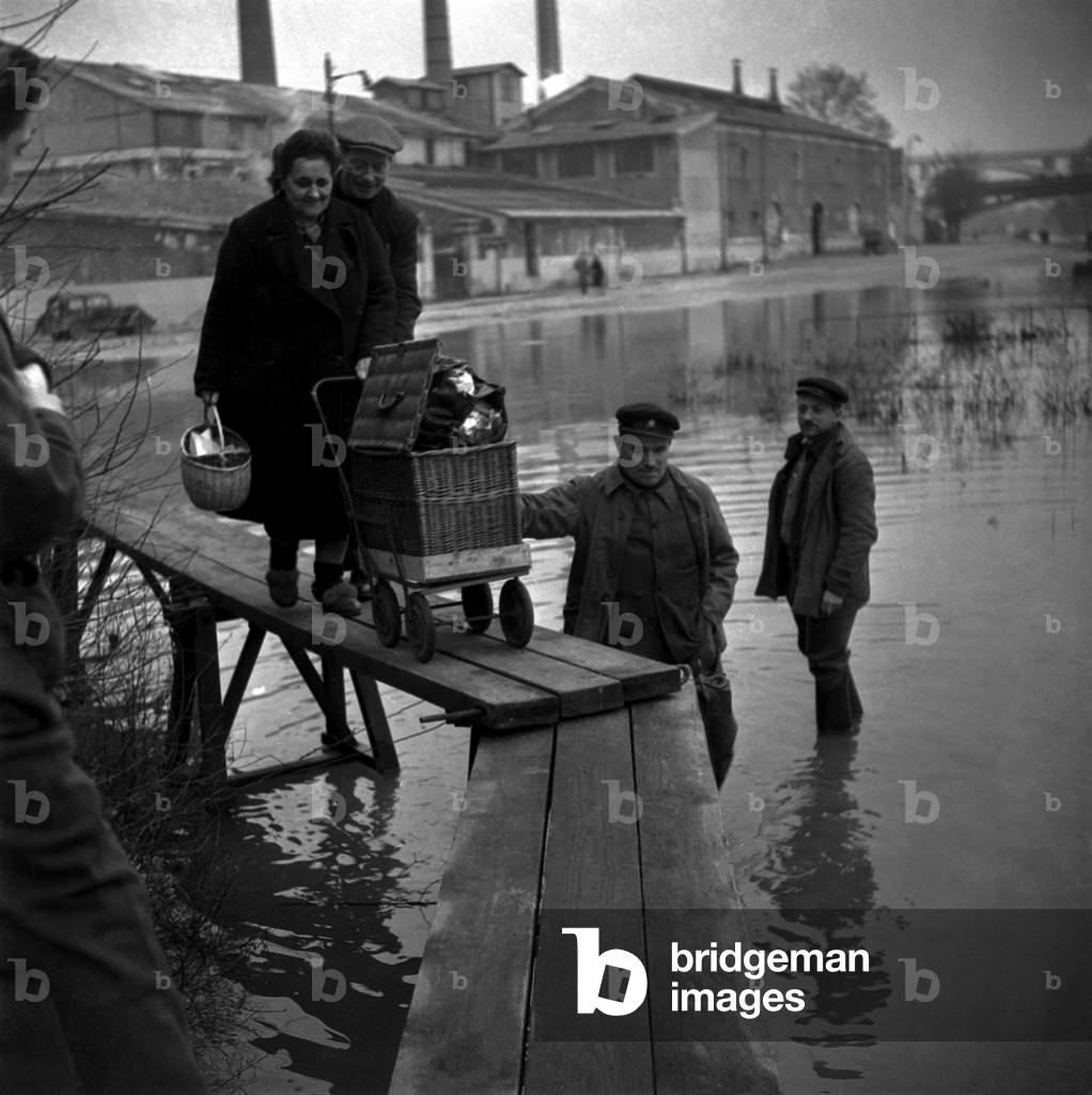 Flood Because of The Level of The Marne River, Near Paris, January 10, 1948 : People Walking on Plancks (b/w photo)