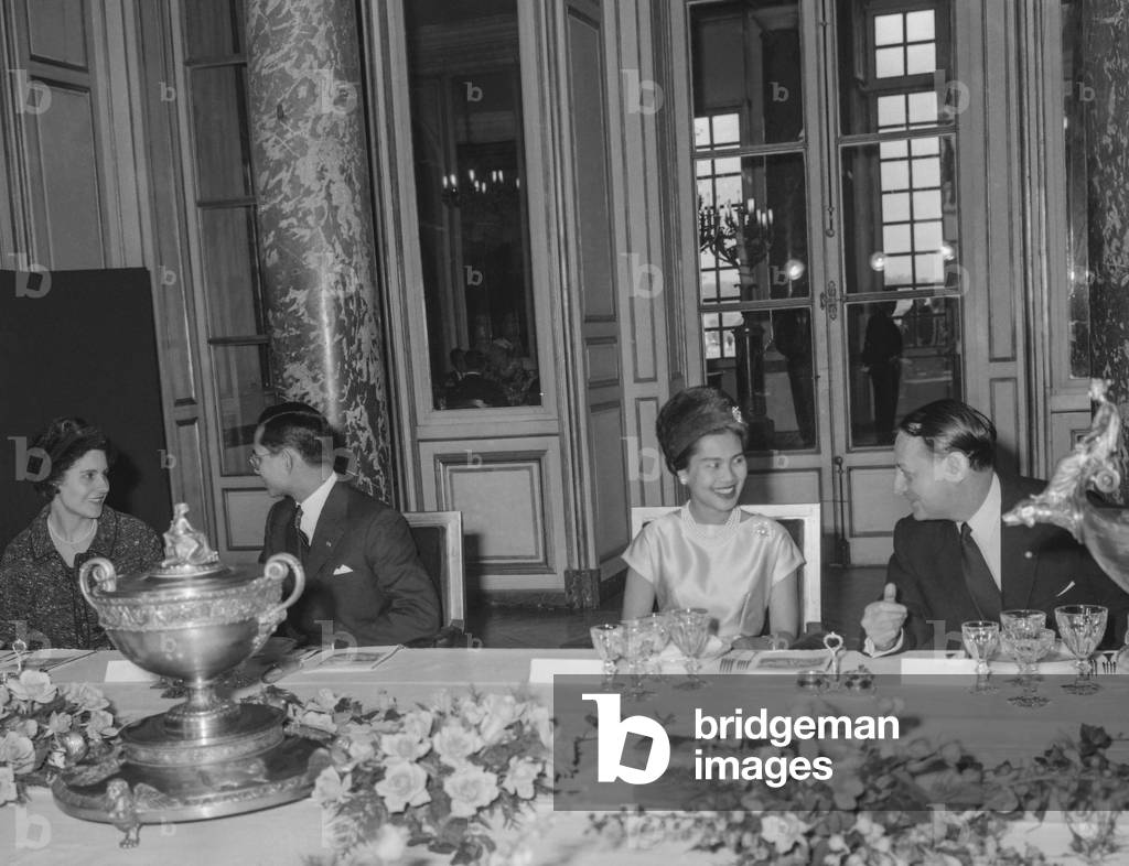 Visit of King Bhumibol Adulyadej of Thailand and queen Sirikit of Thailand in France, October 13, 1960 : here during a lunch in Versailles with French Culture Minister Andre Malraux and his wife Madeleine Malraux (l) (b/w photo)