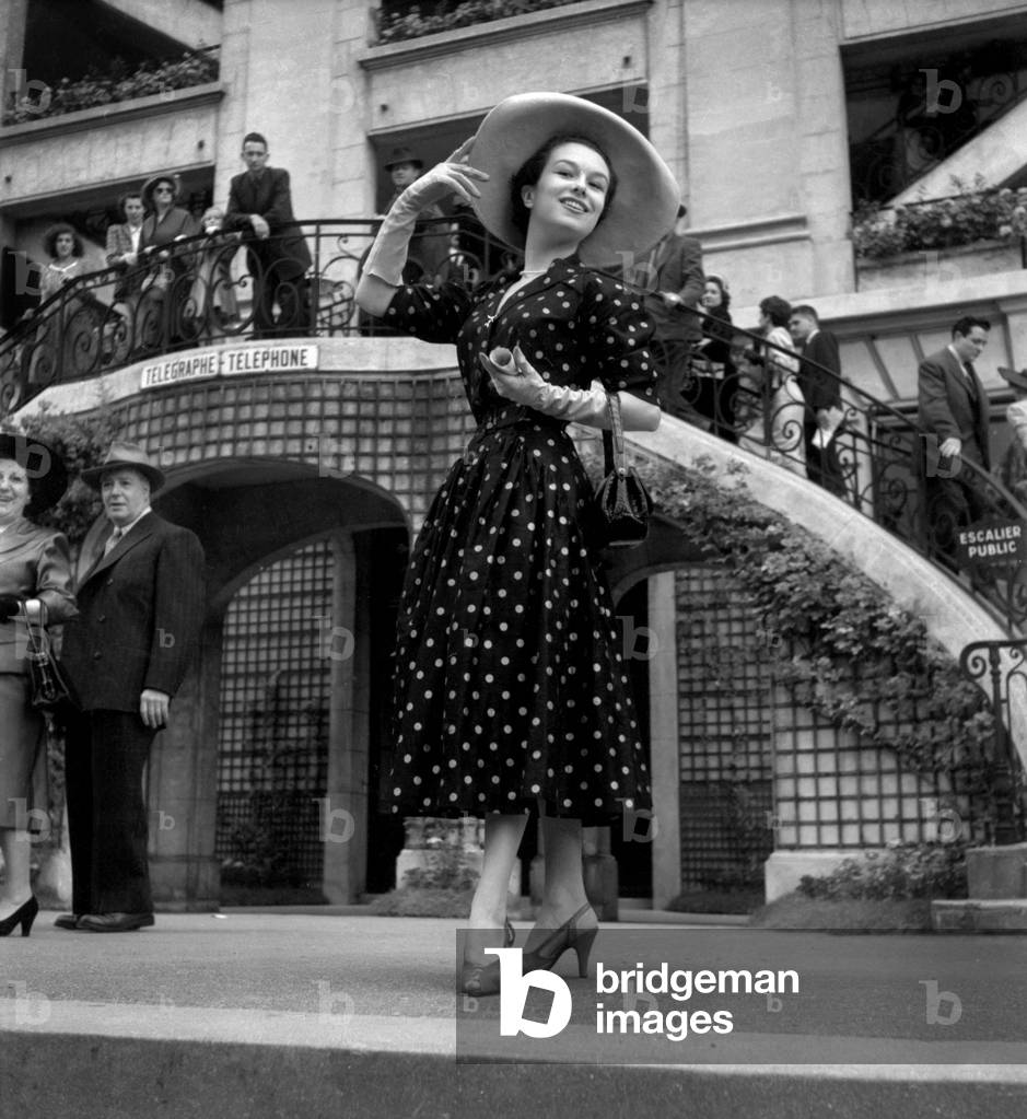 At The Grand Steeple Chase, Auteuil Hippodrome, France : June 22, 1952 : Model Danielle Wearing A Suit By Maggy Rouff, Hat By Marie Christiane (b/w photo)