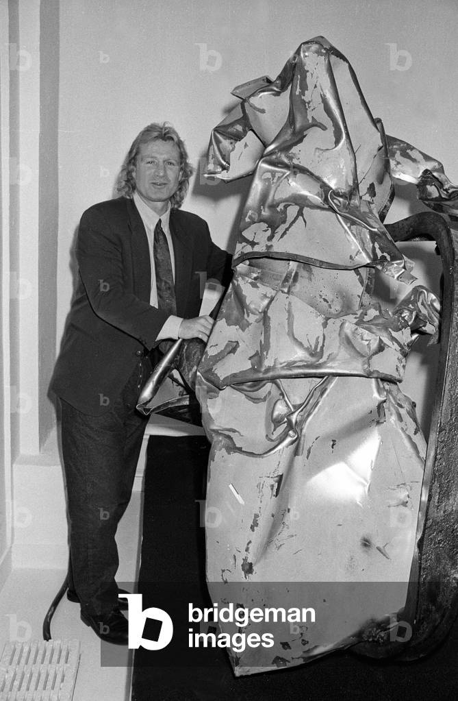 Cx23061 Rugbyman Jean Pierre Rives Exposes His Sculptures At The Galerie Des Chaulnes De Paris Posing In Front Of One Of These Sculptures La Moto November 9, 1990 (b/w photo)