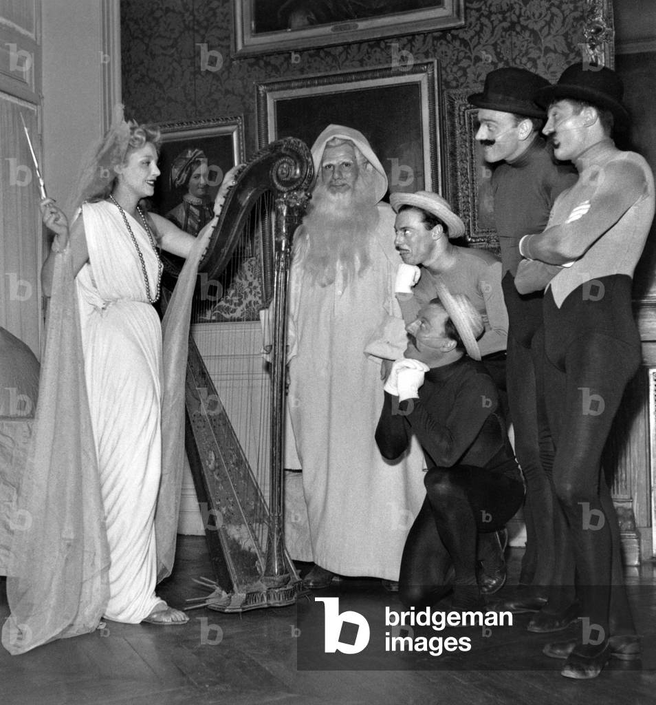 French Actors Michel Galabru Dressed As Father Christmas With Marie Sabouret (L) and the Jacques Brothers (R) at Christmas Show For The Children of French Comedy Staff December 1951 (b/w photo)