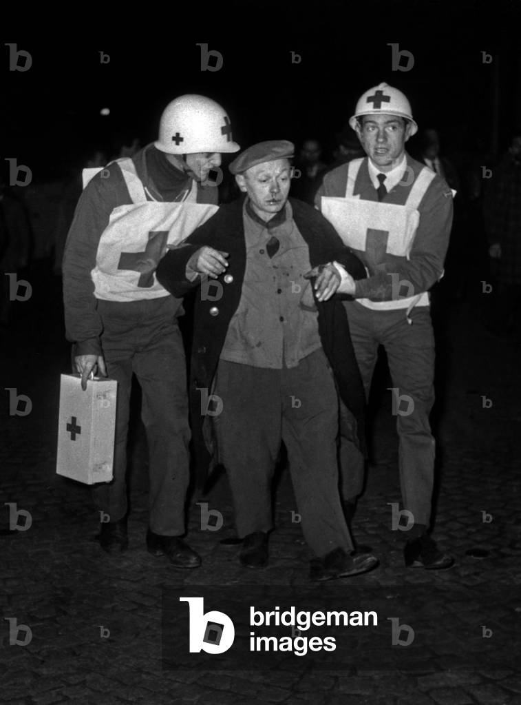 First-Aid Worker of The Red Cross Helping A Wounded Demonstrator at Charonne Station, during A Demonstration Against Oas in Algeria. Paris, France, February 8Th, 1962. (b/w photo)