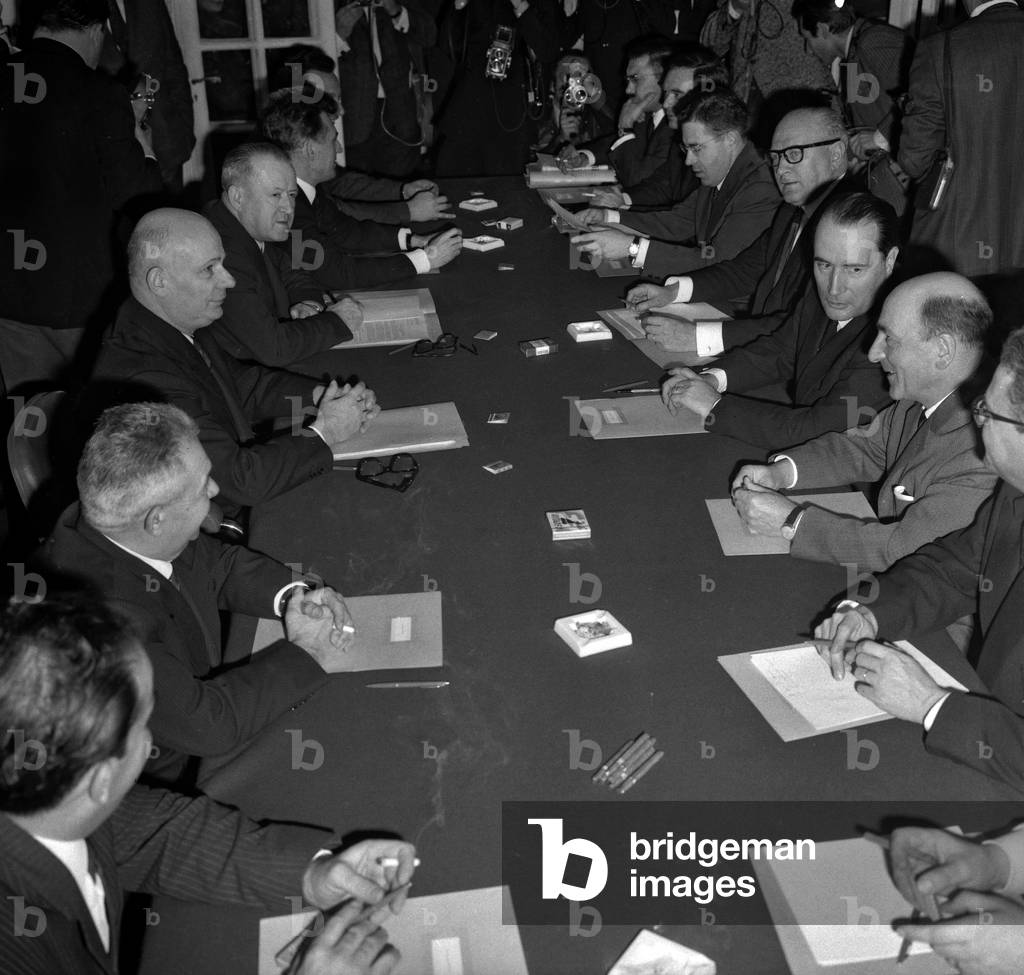 Meeting at the headquarter of the FGDS (Federation of the Democratic and Socialist Left) between the French Communist Party and the Left Federation, December 13, 1966. On l : Communist party : Francois Billoux, Waldeck Rochet, Etienne Fajon, Roland Leroy, on r the delegation of the FGDS : Rene Billeres, Francois Mitterrand, Guy Mollet, Louis Mermoz, Claude Fuzier and Pierre Brousse (b/w photo)