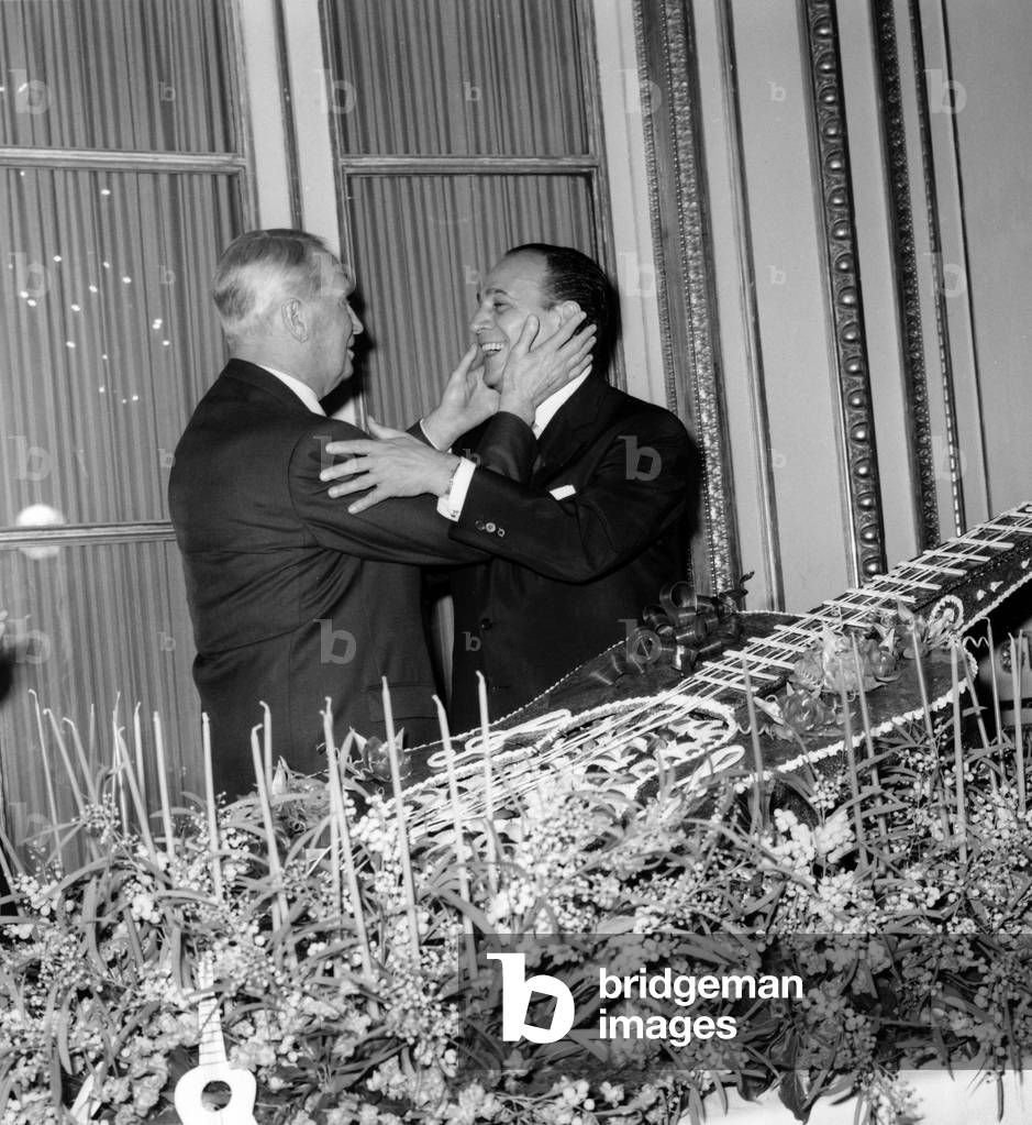 Tino Rossi Congratulated By Maurice Chevalier For his Career Near A Guitar Made With Nougatine, November 1963, Paris (b/w photo)