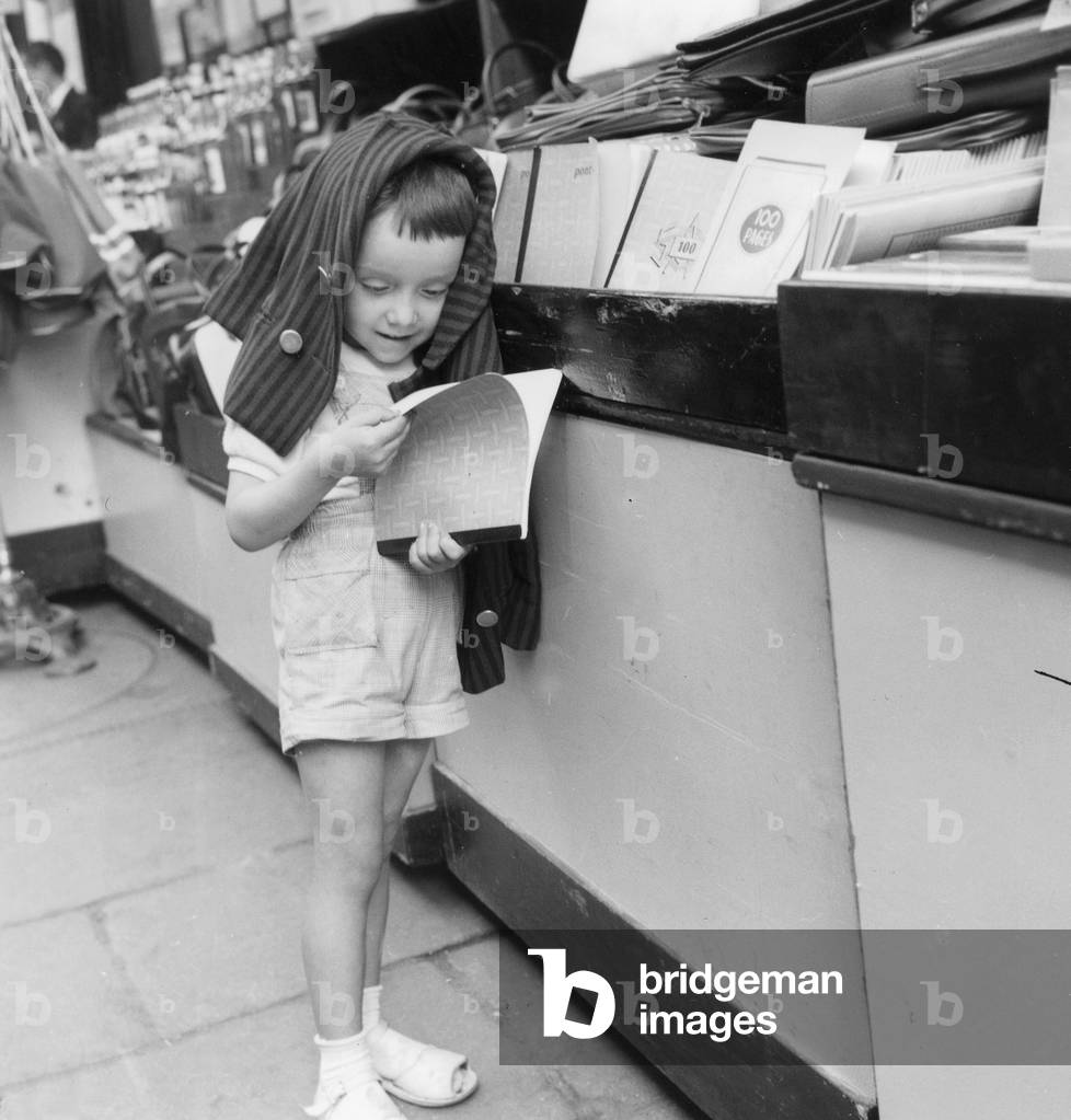 Start of The School Year on September 11, 1958 : A Little Boy Is Looking at School Stationery (b/w photo)