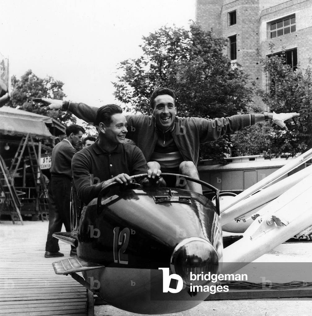 Valentin Huot and Jean Marie Cieleska Celebrating Race Victory on Roundabout Toy Plane in Fun Fair in Bourges France June 24, 1953 (b/w photo)