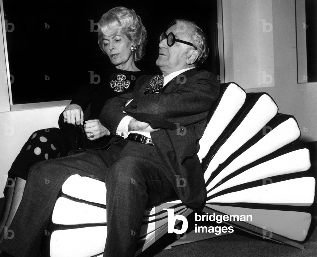 Mrs. Herve Alphand And Marcel Achard Try The New Armchair Cree By Cardin Call “Le Mille-Feuilles” December 2, 1970 (b/w photo)