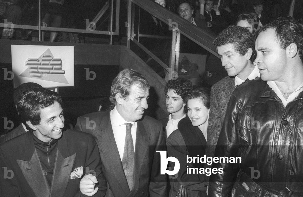 French actors Richard Anconina and Jean Paul Belmondo with French film director Claude Lelouch in 1988 (b/w photo)