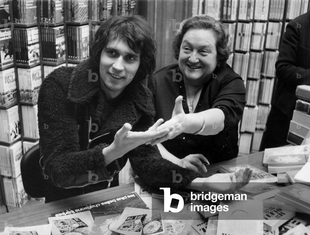 French Astrologer Mme Soleil (Germaine Soleil) Dedicating her Book Predicting Future To Eric Charden December 3, 1971 (b/w photo)