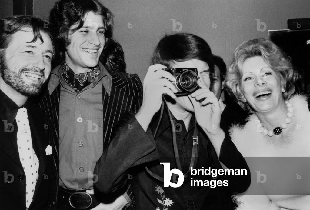 The Premiere of Singer Adamo at The Olympia (Paris) : Louis Velle, Mike Brant, Adamo Et Jacqueline Huet on December 29, 1972 (b/w photo)