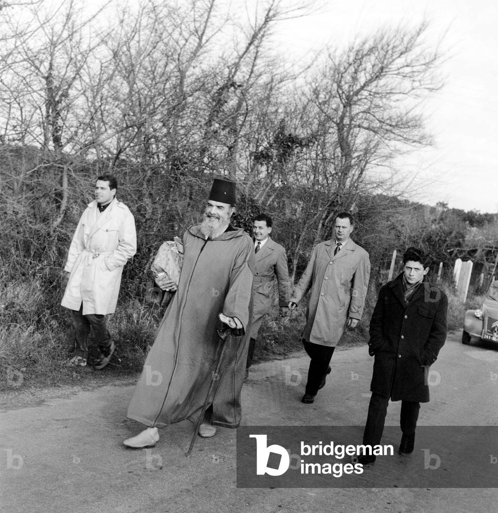 Messali Hadj (1898-1974) Founder of Algerian Nationalism and Leader of Algerian Popular Party, He Was Ordered To House Arrest in Western France in 1952, here in Belle-Ile Escorted By Policemen January 15, 1959 (b/w photo)