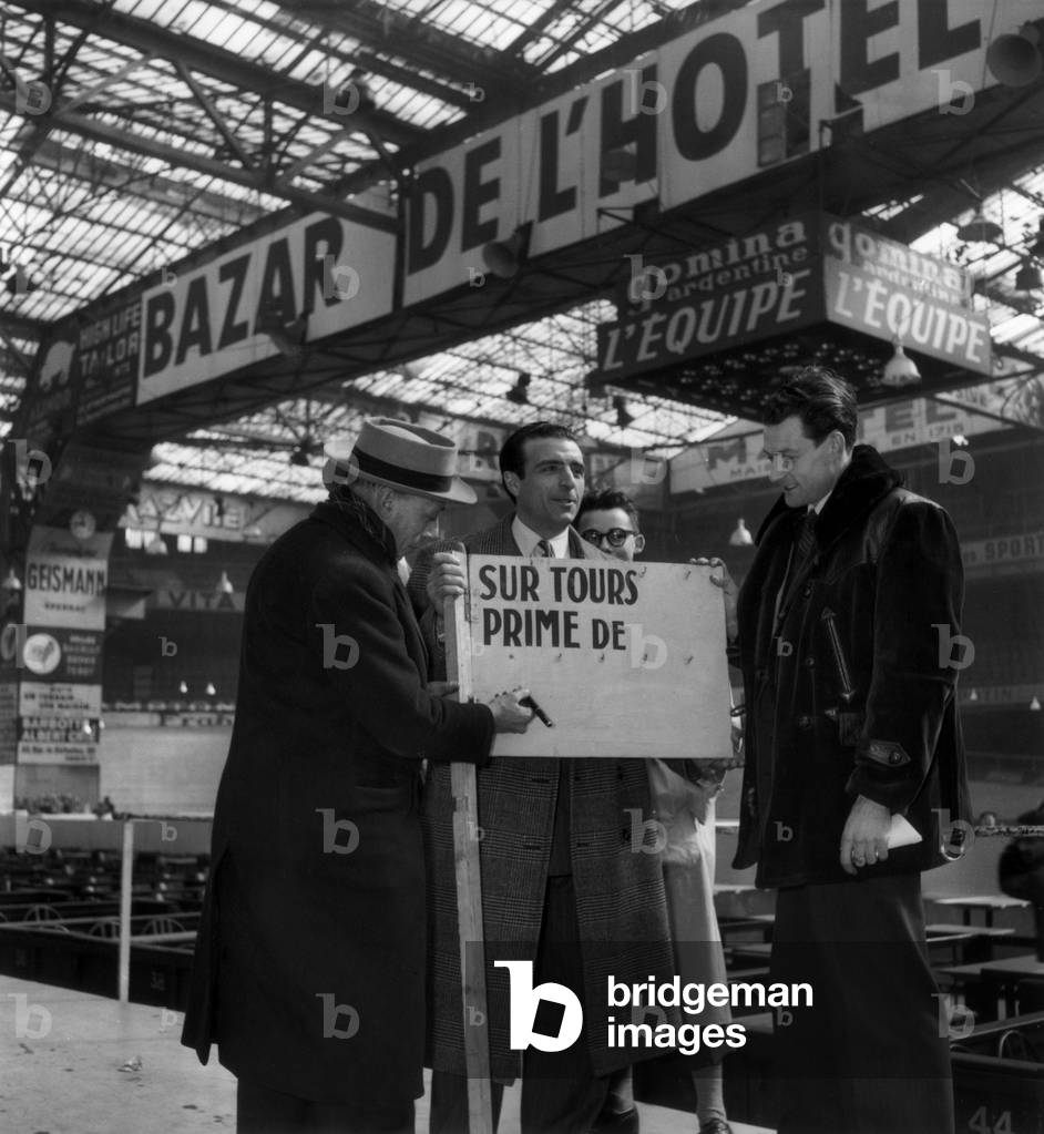 Cyclists Guy Lapebie (C) and Achille Bruneel (R) on March 23, 1949 at The Velodrome D'Hiver, Paris (Before The Competition 