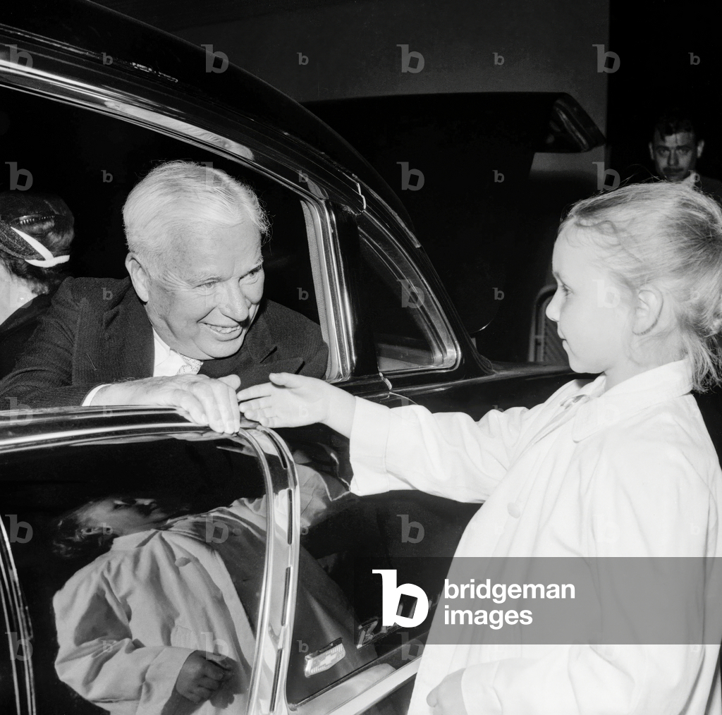 Charlie Chaplin greets a little girl in Orly on September 4, 1957