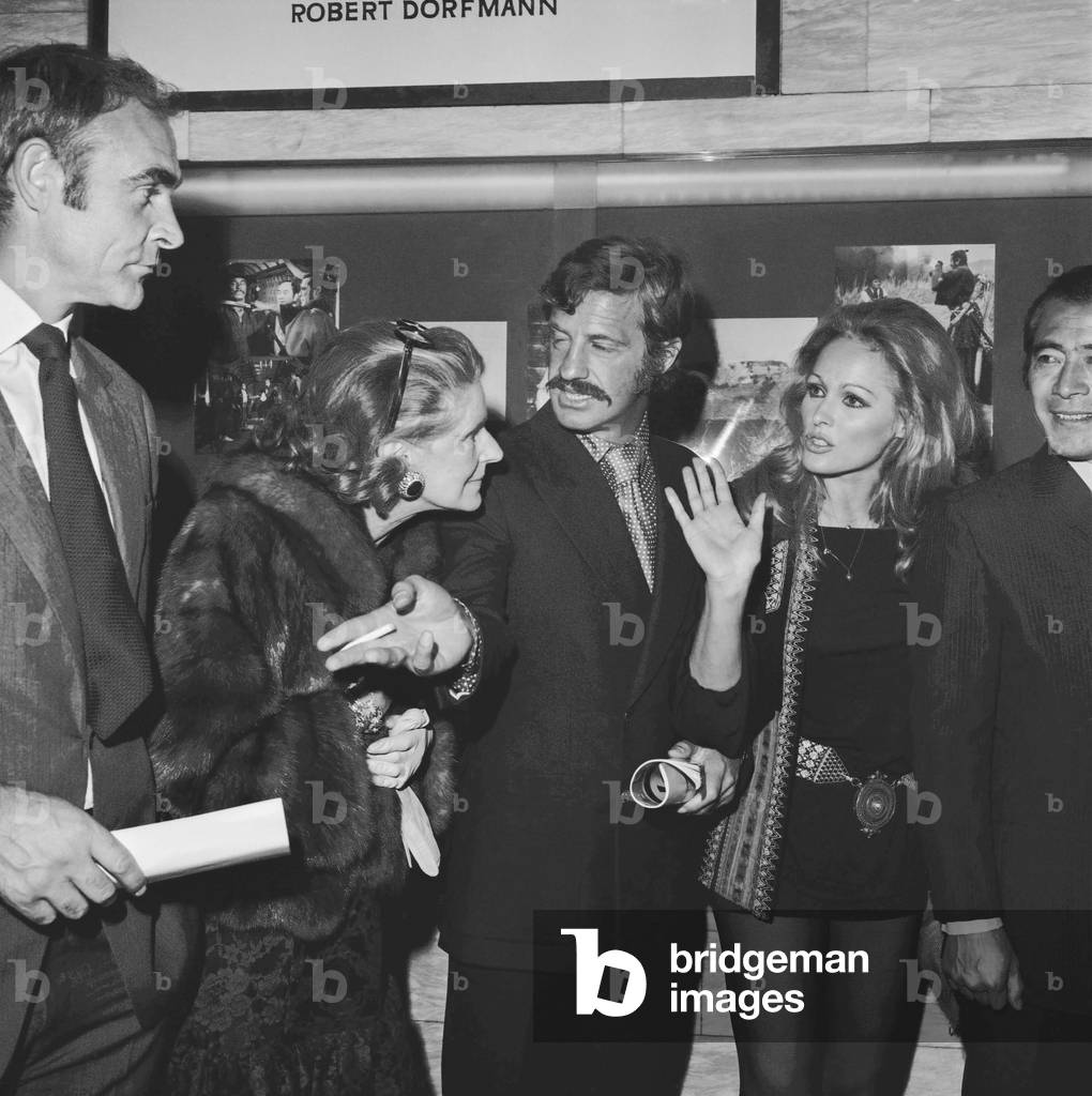 Scottish actor Sean Connery, Lady Orr Lewis, french actor Jean Paul Belmondo, Swiss actress Ursula Andress and Japanes actor Toshiro Mifune at the premiere of film 'Red Sun' in Paris on September 17, 1971 (b/w photo)