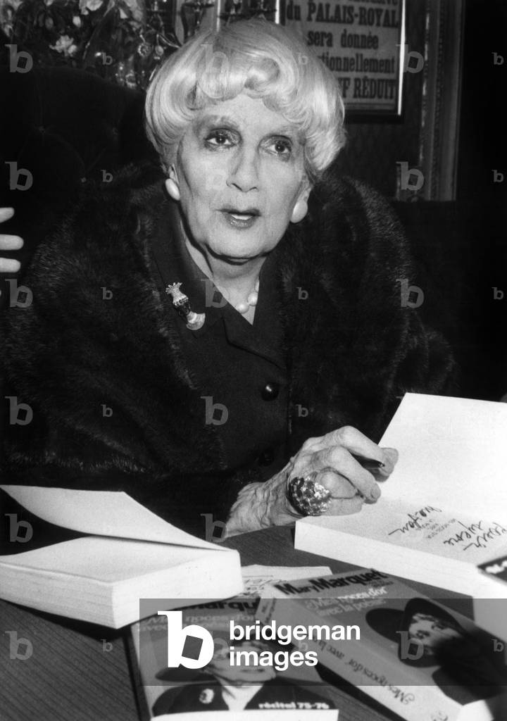 Marie Marquet Signing Copies Of Her Book “Mes Noces D'Or With La Poesie” Au Foyer Du Theatre Du Palais Royal In Paris December 23, 1976 (b/w photo)