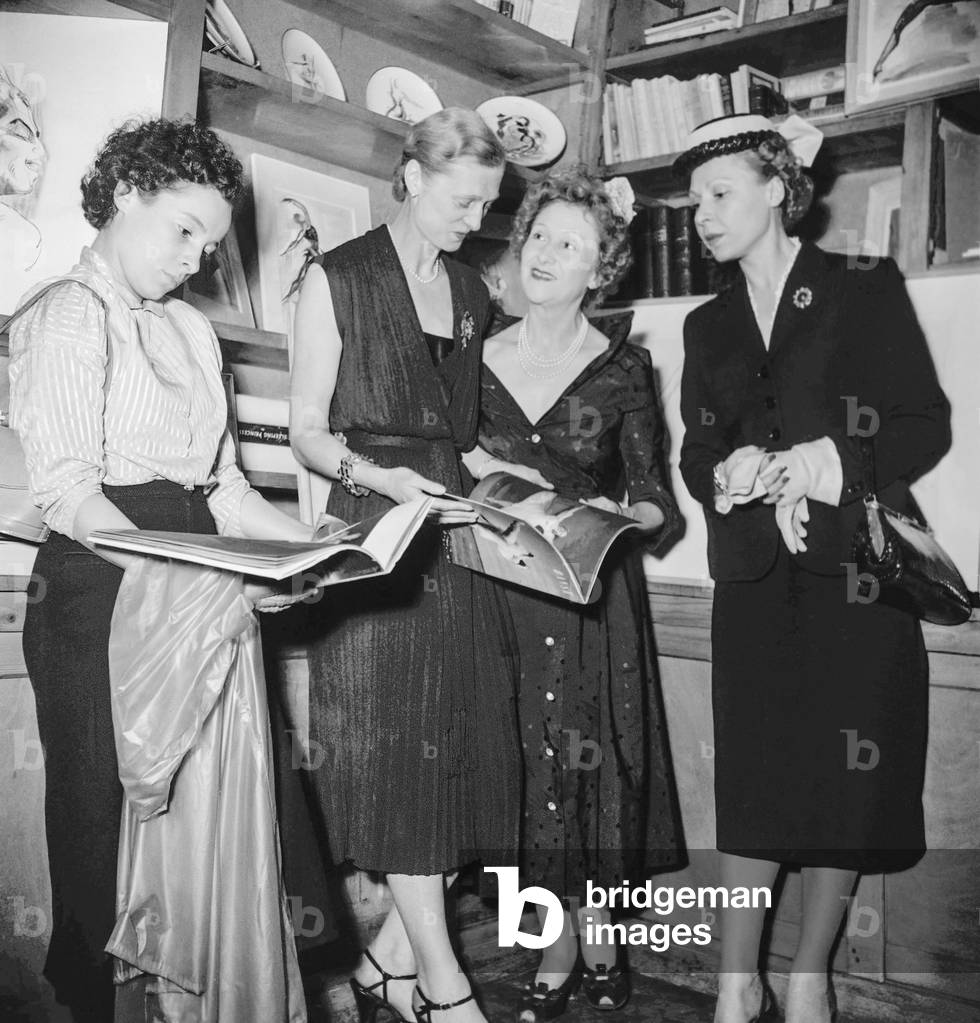 Women in the bookshop of the Place Dauphine, Paris, June 15, 1951 (b/w photo)