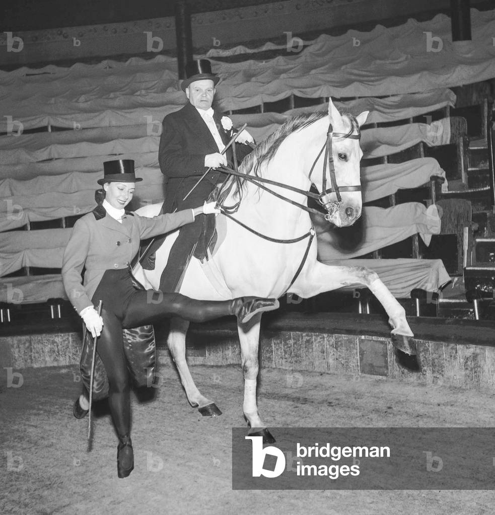 Dancer Michele Marconi with a horse for a show with the Cirque Medrano, Paris, October 17, 1951 (b/w photo)