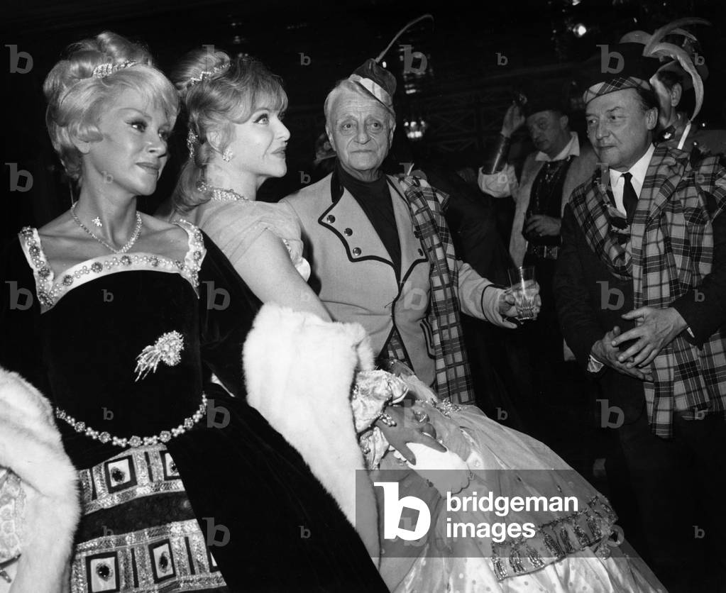 Henri Varna and Loulou Gaste Admiring Line Renaud and Martine Carol at Fancy-Dress Ball on December 4, 1966 in Paris (b/w photo)