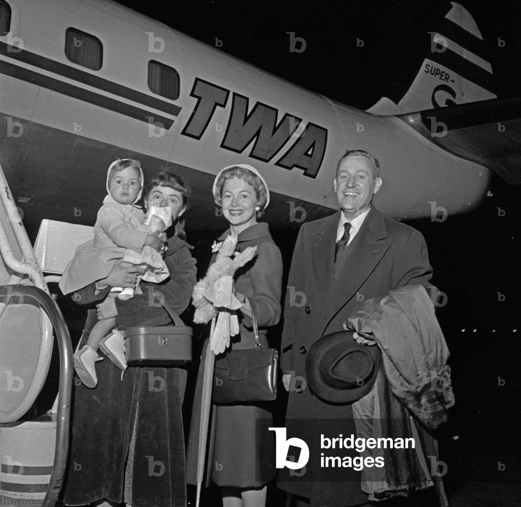 British-American actress Olivia de Havilland with her husband French author and journalist Pierre Galante and their daughter Gisele at Orly airport before flying to the United States of America (USA) on May 22, 1958