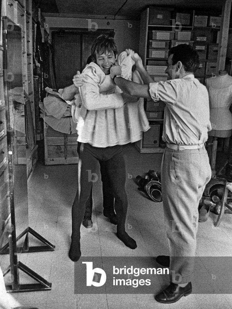 French actor Jean Paul Belmondo trying on his costume on set of film 