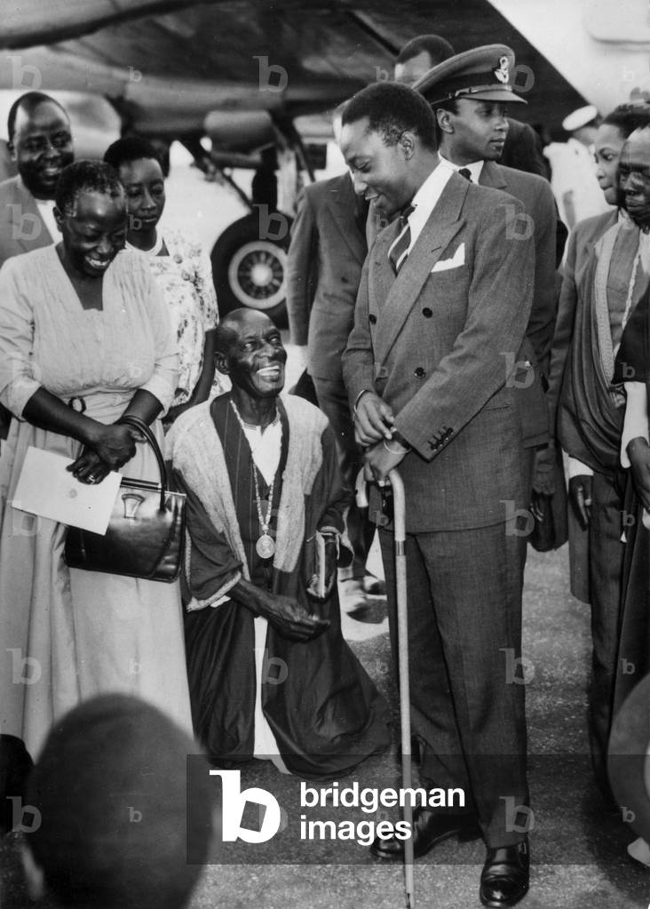 Buganda Kabaka (Right) Welcomed On His Arrival At Entebbe Airport By The Smiling Faces Of His Subjects Behind Him In Air Force Uniform His Brother Prince Kimera October 19, 1955 (b/w photo)