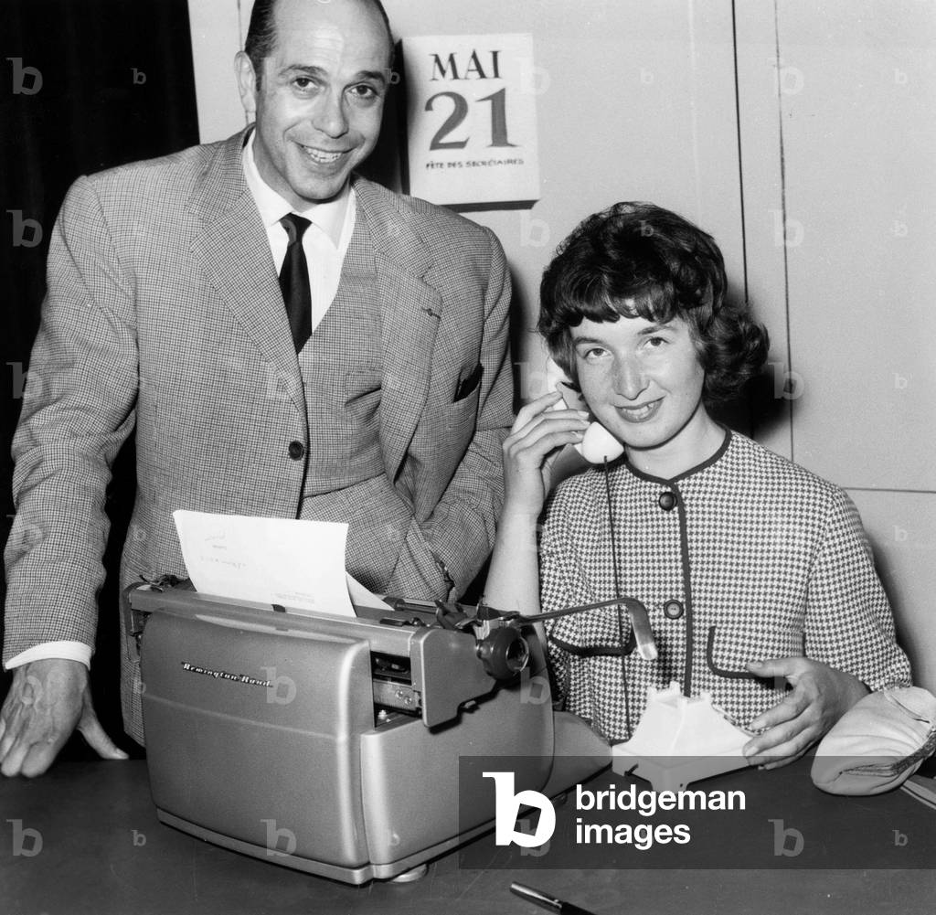 Anne-Marie Moreau Winner of The Competition Miss Secretary 1959 With Robert Manuel Actor of The Comedie Francaise in The Role of The Stressed Visitor, The Winner Gets A Voyage in Three European Capitals and 50 000 Fr May 21, 1959 (b/w photo)