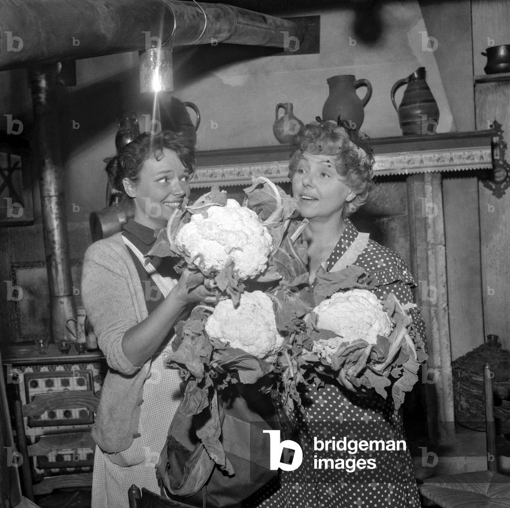 French actresses Catherine Le Couey and Paulette Dubost with cauliflowers on set of film 