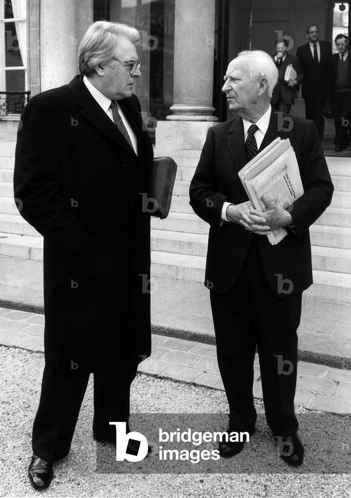 French Prime Minister Pierre Mauroy, and French Minister of Interior Gaston Defferre, Leaving Elysee Palace in Paris After Council of Ministers, April 4, 1984 (b/w photo)