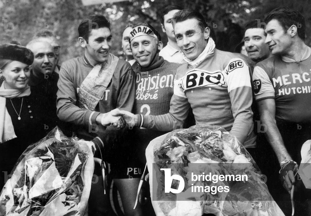 Cyclist Race (Criterium Des As) on October 22, 1967 : Eddy Merckx, Winner, Shaking Hand With Jacques Anquetil Under Look of Raymond Poulidor (R) (b/w photo)