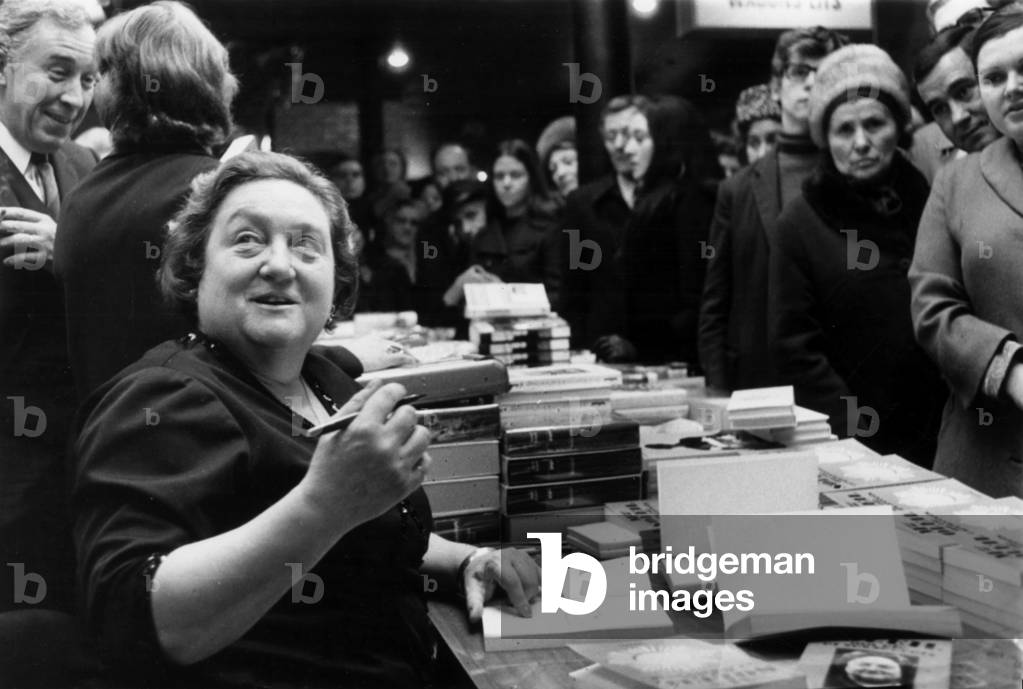 Clairvoyant Mme Soleil Dedicating her Book of Astrology at Drugstore Opera, Paris, December 3, 1971 (b/w photo)