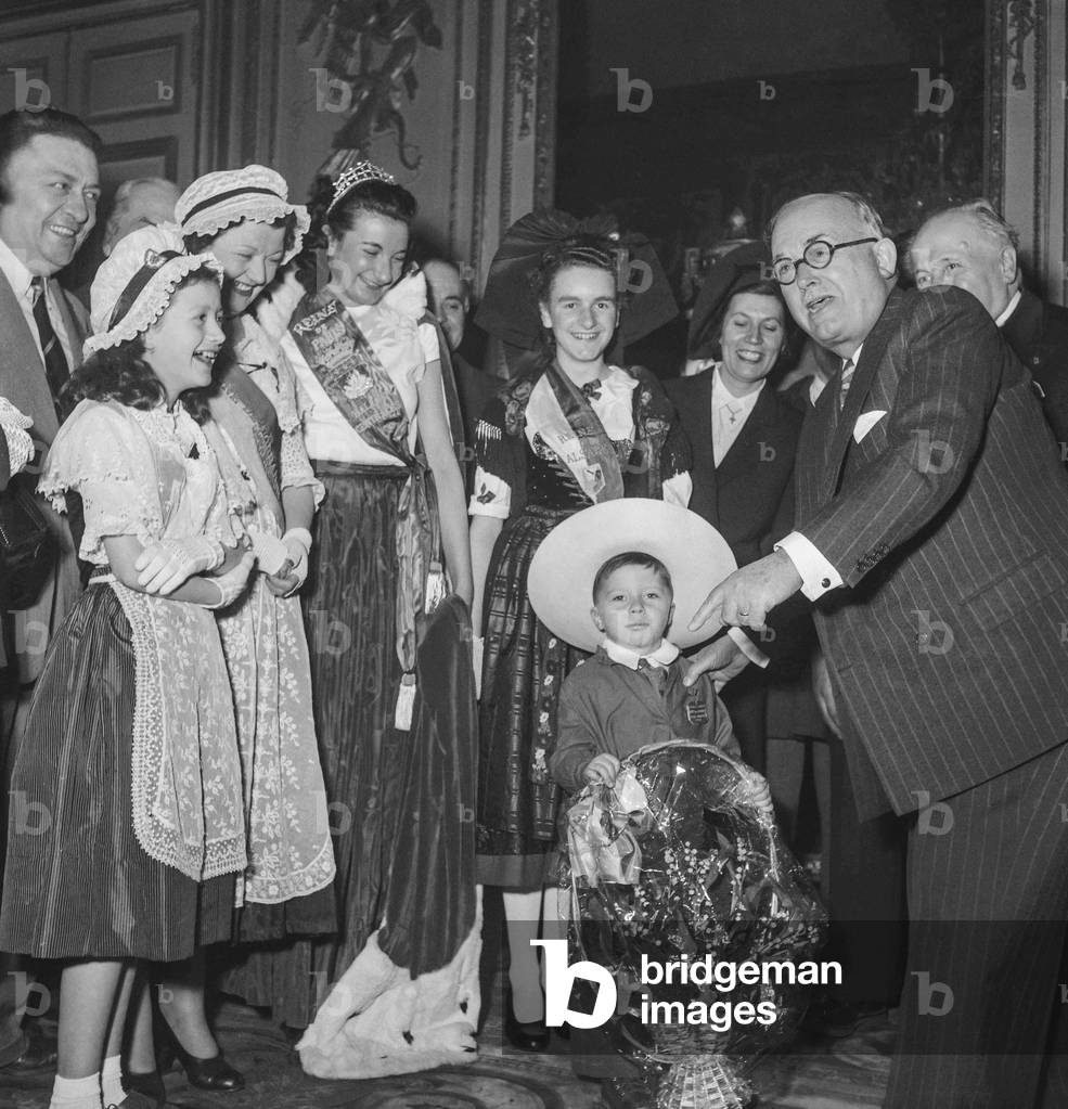 French president Vincent Auriol, young Yves Bonnat and the queen of the Halles (Jacqueline Prunier), Elysee, Paris, May 1st, 1951 (b/w photo)