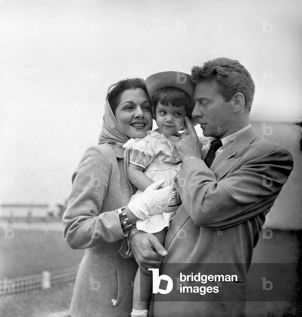 French Actor Jean Pierre Aumont, his Wife Maria Montez and Their Daughter Marie Christine at Orly Airport, Paris, August 17, 1948 (b/w photo)