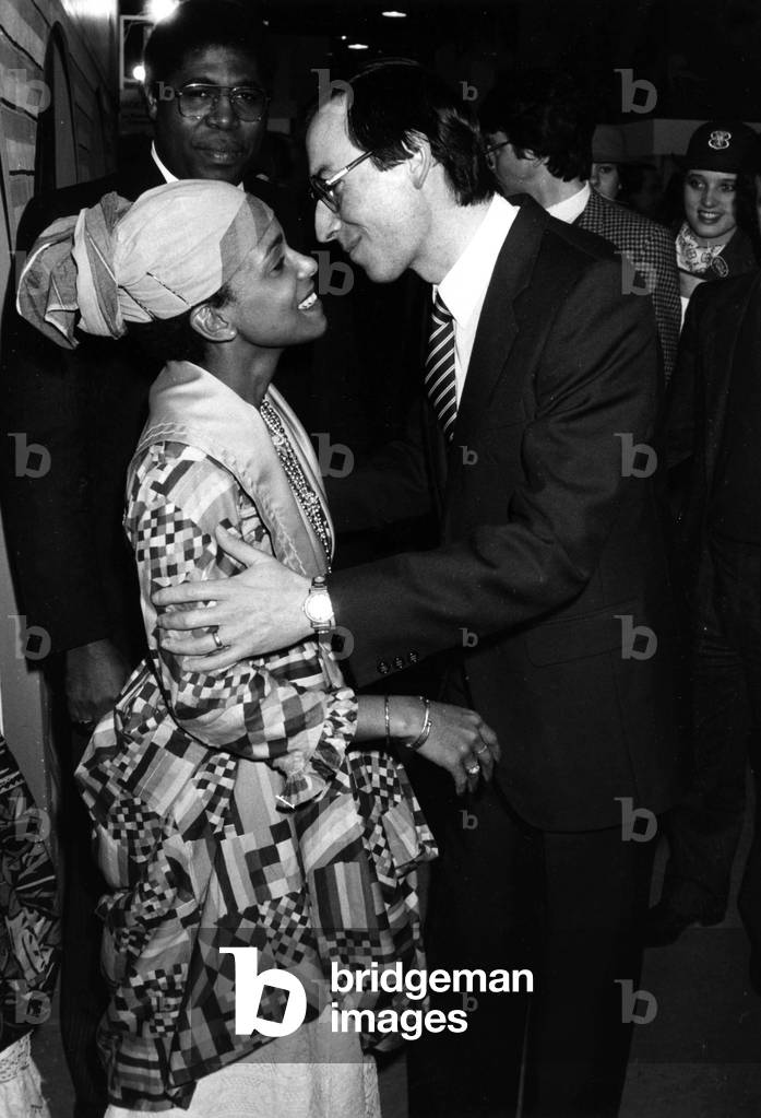 Mr Roland Carraz Secretary of State for Tourism Inaugurating the World Trade Fair for Toursime And Travel At The Cnit Palace Here Welcomed By A Beautiful Caribbean On February 10th 1984 (b/w photo)