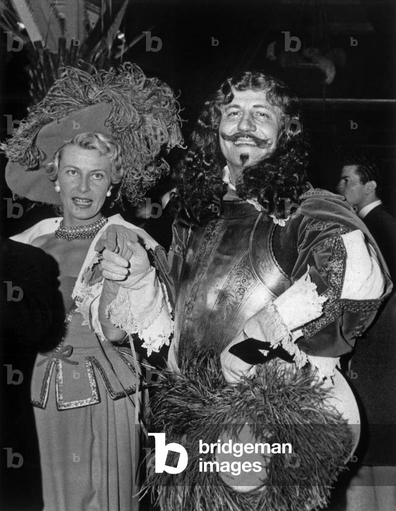 Carnival in Estoril (Portugal) : French Couturier Pierre Balmain and his Fiancee Anne Maillard, February 10, 1959 (b/w photo)