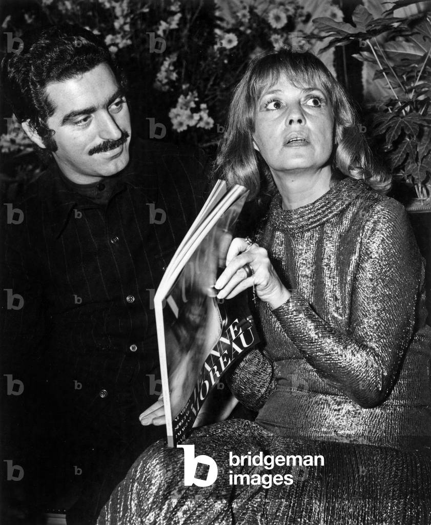 French Designer Paco Rabanne and Actress Jeanne Moreau in Famous Parisian Restaurant Maxim'S To Celebrate Vogue Special Issue December 12, 1970 (b/w photo)