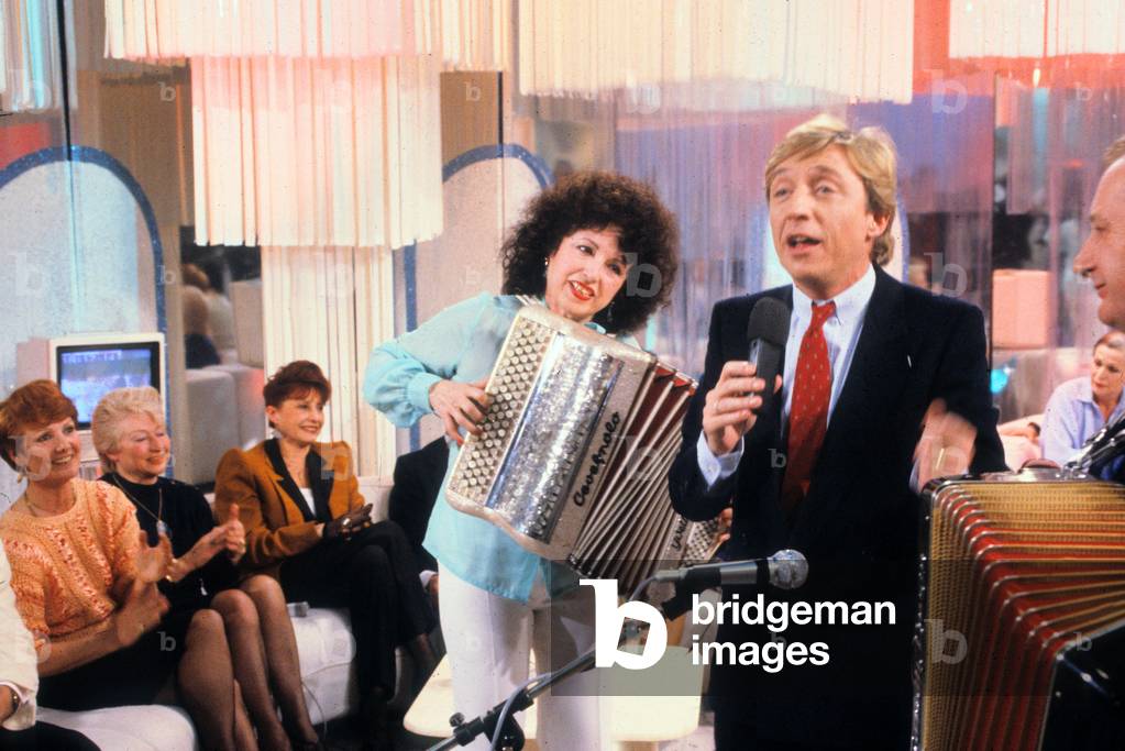 Yvette Horner Playing Accordion during TV Programme With Host Pascal Sevran, March 12, 1985 (photo)
