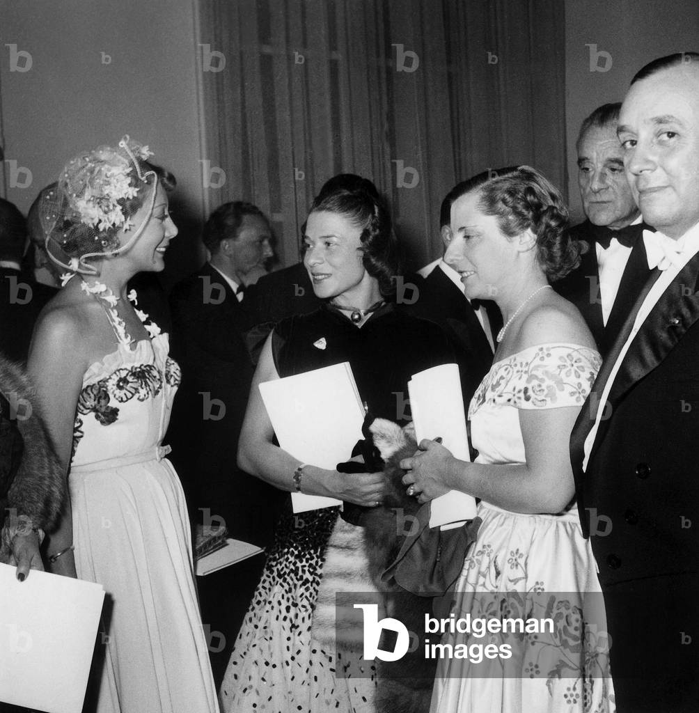 Night of Lace on December 2, 1949 in Paris : Prefect of Police Mr Leonard and his Wife (R) Admirating Dress of Martine of Breteuil (L), Int He C : The Fashion Designer Mrs Carven (b/w photo)