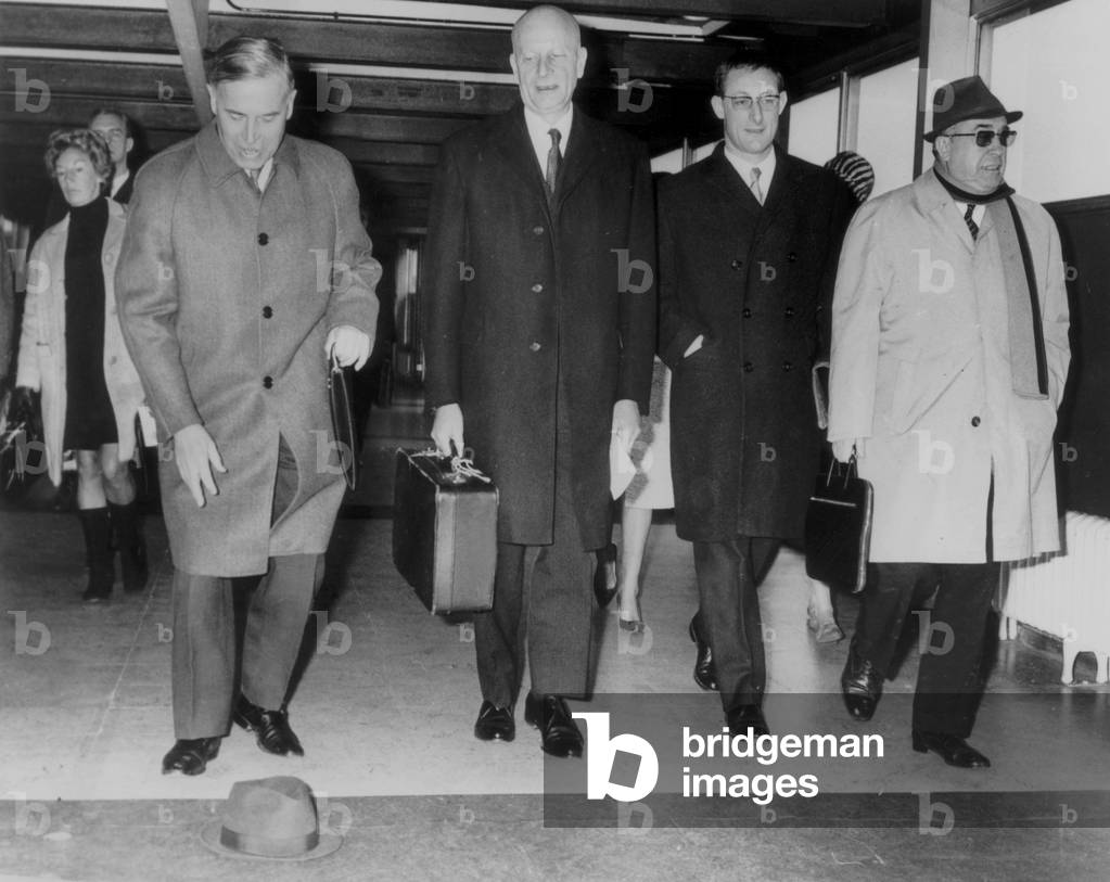 A45499 Before His French Colleagues From The Pan European Union Mr Raymond Triboulet Loses His Hat At London Heathrow Airport Accompanied From Left to Right From Depute Mr Raymond Bousquet Prof. Didier Julia Also Depute And Mr Louis Terrenoire Currently President Of The French Section Of The Pan European Union C Is Under The Egide Of Of It Elsewhere Than They Undertook This Private Journey And Whose The English Waiting He Raise The Cordial Agreement January 31, 1969 (b/w photo)