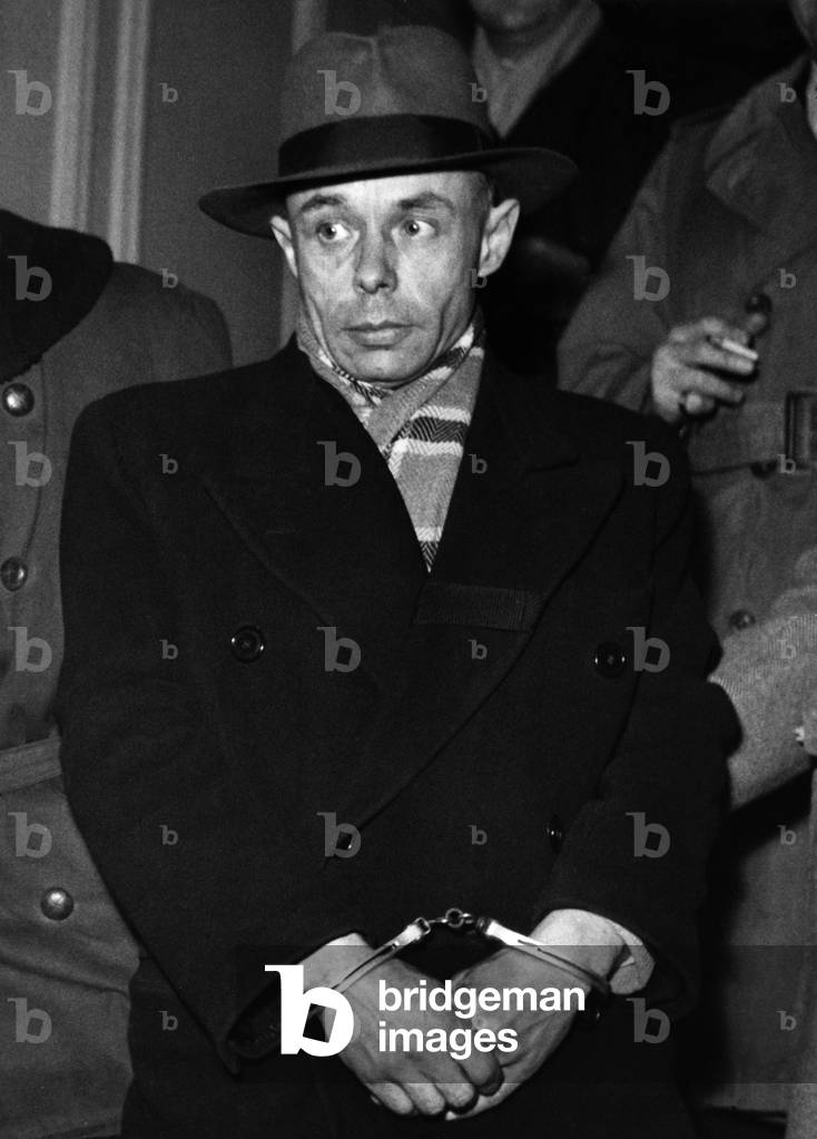 Doctor Duflos Handcuffed after an interrogation in the offices of the 1st Mobile Brigade Rue Bassano. He is considered the murderer of his young wife Olga. January 6, 1950 (b/w photo)