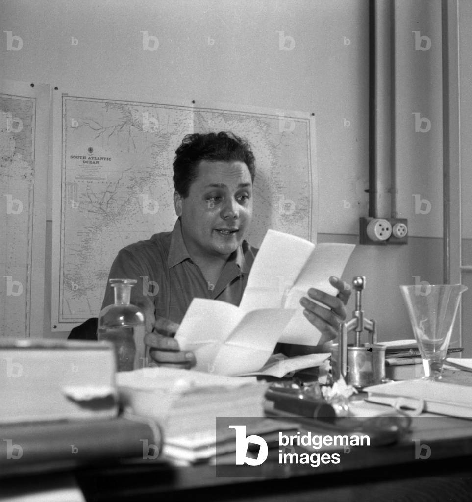 Alain Bombard (1924-2005) in his laboratory at the Musee Oceanographique de Monaco on April 29, 1952 preparing his crossing of the Mediterranean Sea on a raft rubber (b/w photo)